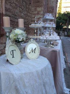 a table topped with two white cakes and candles