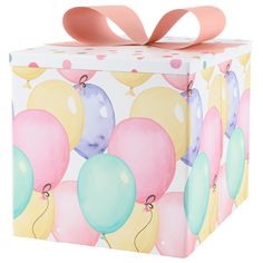 a box with balloons painted on it and a pink ribbon tied around the top,