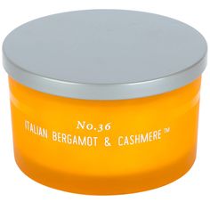 an orange container with a silver lid is shown on a white background and has the words italian bergamot & cashmere in it