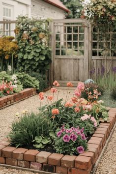 a garden filled with lots of flowers next to a building