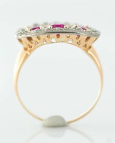 *VIEW A VIDEO OF THIS RING* https://youtu.be/QpIrMvnZT0w Item Description: Here we have an antique 1910s Edwardian Era Ruby Ring featuring an old miner diamond halo, crafted in two tone metal: platinum and 18 karat gold. Features 3 Oval Rubies surrounded by an Old Mine Diamond Halo. This ring has a Platinum top with an 18 Karat Yellow Gold back and shank. Fine filigree detail forms a delicate gallery visible from the profile and underneath. This sweet ring orients horizontally on the finger in a Sweet Ring, Platinum Diamond Engagement Rings, Red Band, Platinum Engagement Rings, Ruby Ring, Antique Rings, Gold Style, Eternity Bands, Halo Diamond