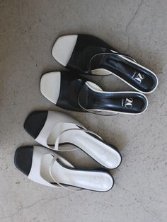 Editor's Notes2comm presents lovely and feminine footwear that is comfortable and practical. - Open square toes- Open upper with cut straps- Contrasting black & white- Wide and low heels- Classic and feminine mood Measurements (in.)- Size: KR 225MM (US 5.5) ~ KR 250MM (US 8)- Heel: 1.18 in.*Fit true to size Composition & Care- Material: Cow Leather- Natural leather may have fine scratches and wrinkles- Bright leather can get stained by denim or dark outfits- Pen and bond m White Low Heel Mules With Heel Strap, White Square Toe Mules With Branded Heel, Modern White Square Toe Sandals, Modern White Mules With Flat Heel, Modern White Flat Heel Mules, Modern White Mules Medium Width, Modern White Mules Of Medium Width, Modern White Flat-heeled Mules, Modern White Flat-heel Mules