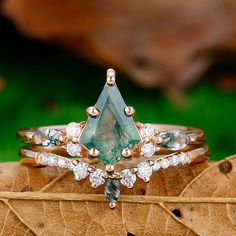 a close up of a ring on top of a leaf with other rings in the background