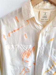 Carny Couture Studios hand painted silk blouse featuring single apricot color on ivory. Abstract faces. Fabric: SilkFit: OSFM Measurements: Bust 44"Sleeve 22" Length 28" Condition: Excellent Orange Silk Blouse For Spring, Apricot Color, Painted Silk, Hand Painted Silk, Abstract Faces, Silk Painting, Silk Blouse, Apricot, Hand Painted