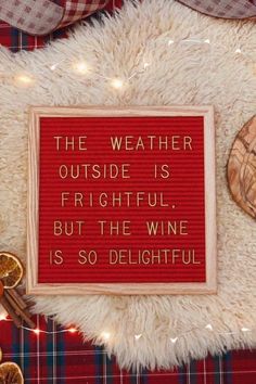 a red sign that says the weather outside is frightful but the wine is so delightful