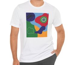 This tee features blue, red, yellow, and green abstract shapes with design elements that have been put together in an abstract collage. Stand out from the others with this bright and colorful t-shirt.  This makes a great gift for the art teacher, for the contemporary art lover, or for the art enthusiast.   This classic unisex jersey short sleeve tee fits like a well-loved favorite. Soft cotton and quality print make users fall in love with it over and over again. These t-shirts have-ribbed knit collars to bolster shaping. The shoulders are tapered for a better fit over time. Dual side seams hold the garment's shape for longer.  .: Made with 100% Airlume combed and ring-spun cotton, a lightweight fabric (4.2 oz/yd² (142 g/m that is easy to layer, breathable. Perfect for active and leisure w Multicolor Abstract Print Casual T-shirt, Casual Multicolor Abstract Print T-shirt, Artistic Cotton T-shirt With Abstract Print, Multicolor Crew Neck T-shirt With Abstract Print, Multicolor Abstract Print Crew Neck T-shirt, Artsy Multicolor Graphic Print T-shirt, Artsy Short Sleeve T-shirt With Artwork, Artistic Expression Multicolor Graphic Print T-shirt, Multicolor Screen Print T-shirt For Artistic Expression