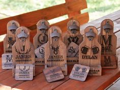 several wooden bottle openers sitting on top of a picnic table next to each other