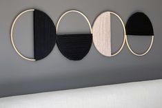 three circles are hanging on the wall above a bed