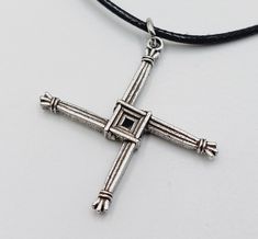 Brigid's Cross Pendant Handmade protection necklace. -Silver cross symbol. - Measurements: Approx. 3.8cm in diameter. - 45cm long black wax cord + 5cm extension chain to adjust to your preferred size. Worldwide Shipping More jewellery, accessories, altar equipment and much more can be found at www.luciferothica.com © Luciferothica.com All Rights Reserved. Info: Brigid's cross or Brigit's cross (Irish: Cros Bhríde, Crosóg Bhríde or Bogha Bhríde) Brigid's cross is typically woven on February 1, he Brigid's Cross, Cross Symbol, Irish Saints, Protection Necklace, February 1, Jewellery Accessories, Silver Cross, Long Black, Necklace Silver