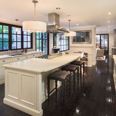 a large kitchen with an island and bar stools