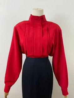 This tops is a classic style!! Excellent condition and soft shoulder pads. This piece is unisex for the style. 38" to 42" chest  18" shoulder to shoulder  27" length Classic Red Blouse For Fall, Classic Fitted Red Blouse, Classic Red Fitted Blouse, Red Retro Formal Tops, Retro Red Formal Tops, Retro Solid Tops For Fall, Solid Retro Tops For Fall, Vintage Solid Color Tops For Workwear, Vintage Solid Color Tops For Work