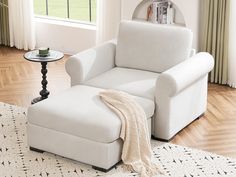 a white chair and ottoman in a living room