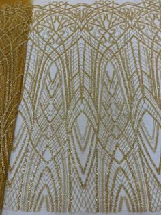 two different types of beaded fabric on white and gold cloth with golden trims