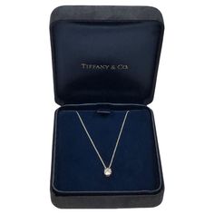 Circa 2010 Tiffany & Company Diamond Solitaire Pendant Necklace, suspended from a 16 inch Platinum chain, a Platinum 4 prong mount holds a .61 Carat Round Brilliant cut Diamond that is G in color and VS in clarity, comes in the original Tiffany presentation box. Current retail price new is approximately $7,900. Pendant Jewelry Tiffany & Co., Tiffany And Co Jewelry, Diamond Solitaire Pendant, Platinum Chain, Solitaire Pendant Necklace, Tiffany And Co, Solitaire Pendant, Round Brilliant Cut Diamond, Diamond Solitaire