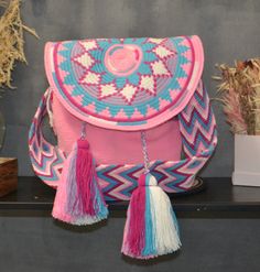 Wayuu Shoulder Bag with flap, Colombian Artisanal, Handmade Crochet, Exquisite Bag in bright spring summer colors, Aztec pattern. Introducing a masterpiece of craftsmanship and cultural heritage, the Wayuu Shoulder Bag, handcrafted in the vibrant heart of Colombia. This shoulder bag is a testament to the rich tradition and artistry of the Wayuu people, an indigenous community renowned for their exceptional weaving skills and distinctive designs. Each bag is a labor of love, created by skilled Wa Wayuu Bags Pattern, Colombian Culture, Wayuu Bag, Indigenous Community, Bright Spring, Aztec Pattern, Summer Colors, Accessories Unique, Cross Body Handbags