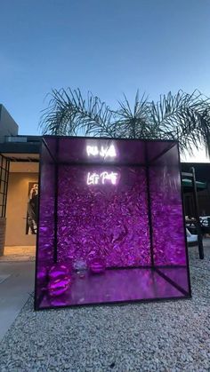 a purple glass box sitting in front of a building