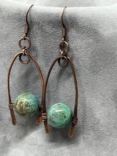 handmade earrings featuring jasper in a teal color with copper settings, unique and beautiful Artisan Jewelry With Natural Stones And Copper, Artisan Copper Jewelry With Natural Stones, Handmade Bohemian Jasper Jewelry, Dangle Jasper Jewelry With Natural Stones, Natural Jasper Stone Dangle Jewelry, Natural Stone Jasper Dangle Jewelry, Earthy Bronze Dangle Jewelry, Copper Dangle Jewelry With Natural Stones, Handmade Bohemian Ocean Jasper Jewelry