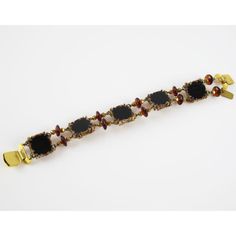 Henry Perichon, a French jewelry designer, created this stunning resin link bracelet adorned with amber-colored glass beads and metallic stones. He revolutionized the plastic jewelry industry with his "rhodoid" invention,  which he extensively used to craft his innovative jewelry. The scored resin setting produces extraordinary examples of costume jewelry, and the bracelet is signed "Henry" on a small gilt metal tag at the clasp. Measurements: The bracelet's total length is 8.87 in (22.5 cm) - w Elegant Brown Gemstone Beaded Bracelets, Elegant Adjustable Tortoiseshell Jewelry, Elegant Adjustable Tortoiseshell Bracelets, Elegant Brown Metal Beaded Bracelets, Elegant Amber Beaded Bracelets, Elegant Adjustable Amber Crystal Bracelet, Adjustable Amber Bracelet For Formal Occasions, Elegant Handmade Tortoiseshell Jewelry, Elegant Bakelite Bracelet Jewelry