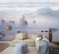 a living room with a large couch in front of a wall mural