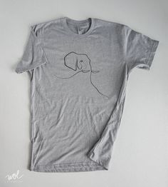 The unique Minimal Elephant is now available for a limited time on premium soft, unisex fit, and it would make the perfect gift for the animal lover in your life. I created this piece using a single line as part of my 'Wild With One Line' series. I hope that you guys enjoy it! Hand silkscreened with water base fashion ink that has an ultra soft hand or feel on the shirt. All t-shirts are Next Level Apparel, 190g/5.6oz., 60% cotton and 40% polyester. WHAT SIZE SHOULD I BUY: T-shirts fit true to s Gray Crew Neck T-shirt With Funny Print, Unisex Gray Short Sleeve T-shirt, Gray T-shirt With Screen Print, Unisex Pre-shrunk Graphic Tee, Gray Graphic Tee With Funny Print, Unisex Pre-shrunk T-shirt For Everyday Wear, Everyday Screen Print T-shirt, Gray Graphic Tee With Custom Print, Elephant Shirt