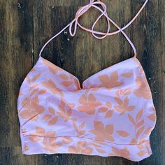 Backless Halter Top. Silky Material. Vibrant Orange And Pink Floral Pattern. Size 4/Small. Tts. Never Worn Pink Crop Top With Built-in Bra, Pink Halter Top With Built-in Bra, Pink Summer Halter Top With Built-in Bra, Pink Sleeveless Crop Top With Built-in Bra, Pink Tops With Built-in Bra For Day Out, Fitted Feminine Pink Halter Top, Pink Triangle Top With Built-in Bra, Pink Crop Top With Built-in Bra For Vacation, Spring Party Halter Top Bra Friendly