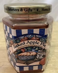 a jar of baked apple pie sitting on a counter top next to a sign that says baker's & gift's honey