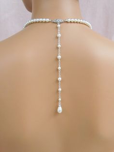 "Glamorous yet simple and elegant! I've created the Alyssa Jewelry pieces using Swarovski pearls and crystal component for a classic and elegant look. The beautifully detailed filigree clasp is custom designed by me. Backdrop measures 8\". If you want the backdrop longer or shorter, please message me! Alyssa Earrings measure 1.5\" (36mm) Front necklace drop measures 1.5\" (36mm) Shown with white/light ivory Swarovski pearls. Also available with cream or cream rose Swarovski pearls. Please state