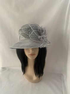 1920 vintage inspired silver gray cloche brim bucket style hat with feather flower hat elegantly designed to wear as a COGIC Women's Convention hat. Looking for a lightweight spring to summer Mother of the bride wedding hat? This silver and gray Pearl scalloped bordered trim hat is ideal for any formal special occasion. Mother's Day brunch or tea Party gift idea for mom. Lightweight Easy to wear Can wear Brim up or down or with one side up while the other down. Looking for something but can't seem to find it?  Let's customize something together Silver Wide Brim Costume Hat With Adjustable Fit, Silver Wide Brim Adjustable Costume Hat, Silver Adjustable Wide Brim Costume Hat, Silver Brimmed Party Hat, Silver Wide Brim Costume Hat For Party, Elegant Silver Hat For Kentucky Derby, High Crown Silver Hat For Party, Silver High Crown Hat For Party, Elegant Gray Summer Hat