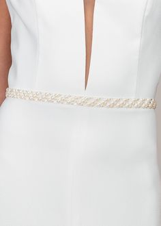 The ISABELLA sash has become one of our best sellers and will add some romance to your bridal look. Made with a mixture of pearls and see-through clear crystals to add a subtle touch of sparkle, this glamorous wedding belt will not disappoint. The pearls and crystals are hand-applied to a soft organza ribbon to blend in with your wedding gown. This accessory is available in bright white or trendy ivory. The belt measures 72 inches long, and the ribbon can tie in the back making the piece one siz Luxury Designer White Belt, Bridal Belts, Classic Pearl Necklace, Wedding Belt, Pearl Accessories, Wedding Sash, Bridal Sash, Wedding Belts, Pearl Design