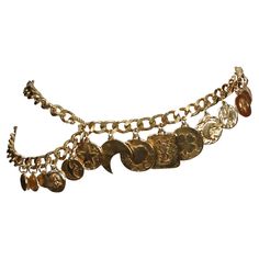 Very rare gilt charm belt designed by Yves Saint Laurent dating to the early 1990's. This fabulous belt features 16 coin charms suspended from a 37" linked chain from end to end which can be worn a few different ways including a necklace if you are creative. Charms include a heart, moon, star, clover, bird, fleur-de-lis, and large 'YSL' rectangular piece at center front. Belt as shown on a 24" waist. Very impressive belt. Good condition. Dope Jewelry Accessories, Punk Vintage, Chain Belts, Belt Design, Belly Chain, Vintage Belts, Chain Belt, Girly Jewelry, Gianni Versace