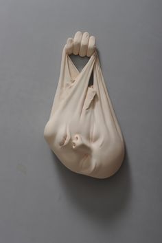 a plastic bag that has been made to look like a hand holding something in it