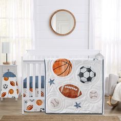 a baby crib bedding set with sports balls and stars