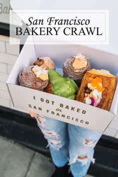 a person holding a box filled with baked goods and the words san francisco bakery crawl