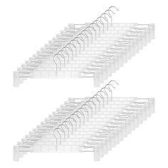 two rows of clothes hangers with clips attached to each other, on white background