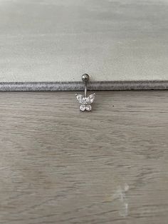 a close up of a pair of earrings on a wooden floor with a white background