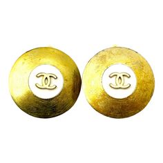 This is part of Chairish’s Costume Jewelry assortment.  Chanel Gold Plated CC White Disc Clip On Earrings  *Marked 94 *Made in France *Comes with the original box  -It is approximately 1.25" x 1.25". -It is classic and beautiful. -There are some stains on the metal. -In a good vintage condition 1990s Chanel, Pink Stud Earrings, Vintage Rhinestone Earrings, Ruby Earrings Studs, Blue Stud Earrings, Starburst Earrings, Van Cleef And Arpels, Pink Studs, Contemporary Earrings