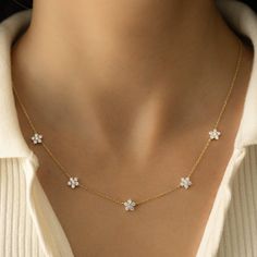 Super cute flower necklace is delicate and a true stunner. It looks great on its own, or can also be worn layered! Made of 925 Sterling Silver 14K Gold plating Nickel-free & Hypoallergenic Highest grade CZ's for an authentic look! Flower size: 6mm Total of 5 flower charms Chain: 16" + 3" extension chain Lobster clasp closure Cheap Adjustable Chain Flower Pendant Necklace, Everyday Flower Pendant Necklace, Delicate Flower Shaped Necklace With Clavicle Chain, Delicate Flower Necklace With Clavicle Chain, Fine Jewelry Flower Pendant Necklace, Elegant Everyday Necklace With Flower Charm, Elegant Flower Shaped Necklace With Adjustable Chain, Delicate Flower Necklace For Anniversary, Dainty Flower Charm Necklace For Everyday