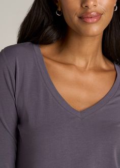 About Our Long Sleeve Scoop V-Neck Tee Shirt for Tall Women There’s something beautiful about basics. They’re the building blocks of your wardrobe and the staples of your everyday outfits. Your essentials should always fit perfectly, so we set out to create the fundamental Long Sleeve Scoop V-Neck Tee shirt for tall women. This women’s tall top has been tailored for your shape and height with extra-long sleeves and an extended hemline. The front features a casual scoop v-neck while the rear hem Solid V-neck Tops In Modal, Everyday Seamless V-neck Tops, Basic Gray V-neck Tops, Jeans For Tall Women, Scrubs Dress, Athleisure Summer, Cozy Sleepwear, Extra Long Sleeves, Long Sleeve Tee Shirts