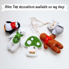 there are several stuffed animals hanging on the string with words above them that read, other tree decorations available on my shop