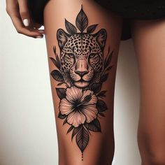 a woman's thigh with a leopard and flowers tattoo on it