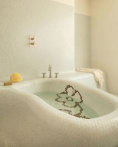 a bathroom with a large white bathtub in the middle of it's walls