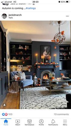 a living room filled with furniture and a fire place next to a book shelf full of books