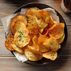 a plate full of potato chips with parsley on top