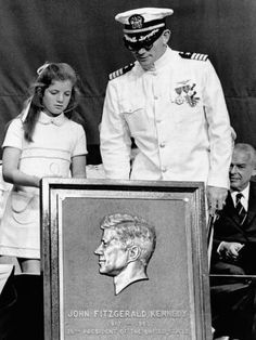 an old black and white photo of two people standing next to a portrait of john fitzgerald