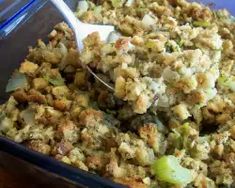 a casserole dish is filled with stuffing and vegetables, ready to be eaten