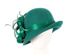 Exclusive green felt winter fashion hat from latest Fillies Collection. Elegant shape decorated with silk abaca loops and feathers. Perfect for everyday wear or winter race events.  Made in Australia  Renown Fillies Collection brand  Winter fashion hat  Fits up to 58cm Winter Party Cloche Felt Hat, Winter Party Felt Cloche Hat, Winter Feathered Flat Brim Felt Hat, Winter Felt Hat With Feathers And Flat Brim, Winter Felt Hat With Feathers And Short Brim, Fur Felt Hat With Short Brim For Party, Elegant Feathered Hat For Winter, Elegant Feathered Winter Hats, Elegant Winter Hats With Feathers