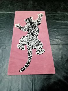 a pink area rug with an image of a woman in leopard print on the floor