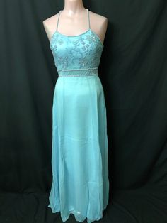 "This beautiful long powder blue gown has beaded spaghetti straps and a decorated bust.  It is fitted through the chest and waist and flares out from the hips.  This gown is in excellent condition and available in different sizes.  Measurements for this gown are in a Size : Size-4                                       Size-8                                Size-10                                 Size-12                        Size-14                                       Chest - 31\" Spaghetti Strap Gown For Debutante Ball And Prom Season, Light Blue Spaghetti Strap Wedding Dress, Light Blue Evening Dress With Fitted Bodice For Prom, Light Blue Fitted Bodice Evening Dress For Prom, Light Blue Floor-length Evening Dress For Debutante Ball, Light Blue Fitted Evening Dress For Prom, Blue Spaghetti Strap Evening Dress For Homecoming, Spaghetti Strap Gown For Homecoming And Prom, Light Blue Gown With Sweetheart Neckline For Debutante Ball