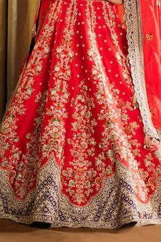 Red can can attached lehenga featuring zardozi-thread embroidered floral jaal motifs along the panels, contrast purple patchwork hemline, embellished by sequins. Comes with beaded tassel embellished padded blouse and scalloped border dupatta. - Aza Fashions Red Gown With Dori Work For Traditional Ceremonies, Traditional Wedding Gown With Motifs, Red Anarkali Lehenga With Motifs, Festive Gown With Motifs, Red Floor-length Dupatta With Motifs, Festive Wedding Lehenga With Motifs, Festive Lehenga With Motifs For Wedding, Wedding Lehenga With Motifs For Festivals, Red Traditional Wear With Motifs For Reception