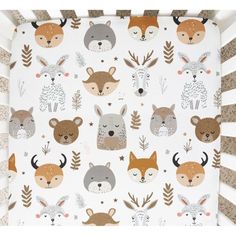 a crib sheet with woodland animals on it